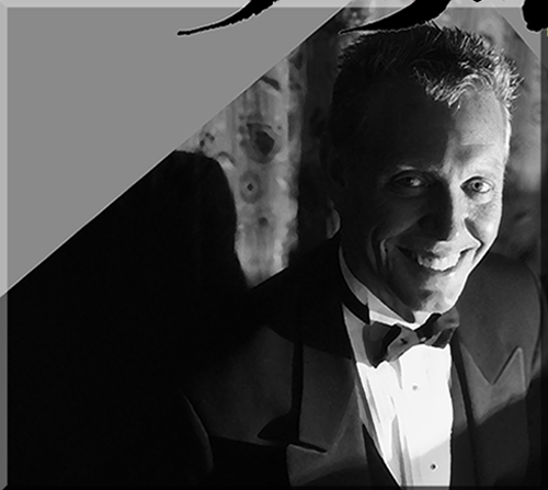 photo of Jerry Michelsen smiling at the keyboard in a tuxedo
